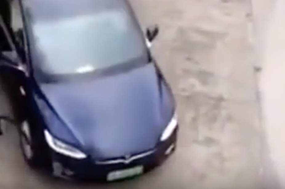 On the way out, the Model X owner scrapes the car next to it and rips off a piece of their car which is stuck on to the Model X's wheel